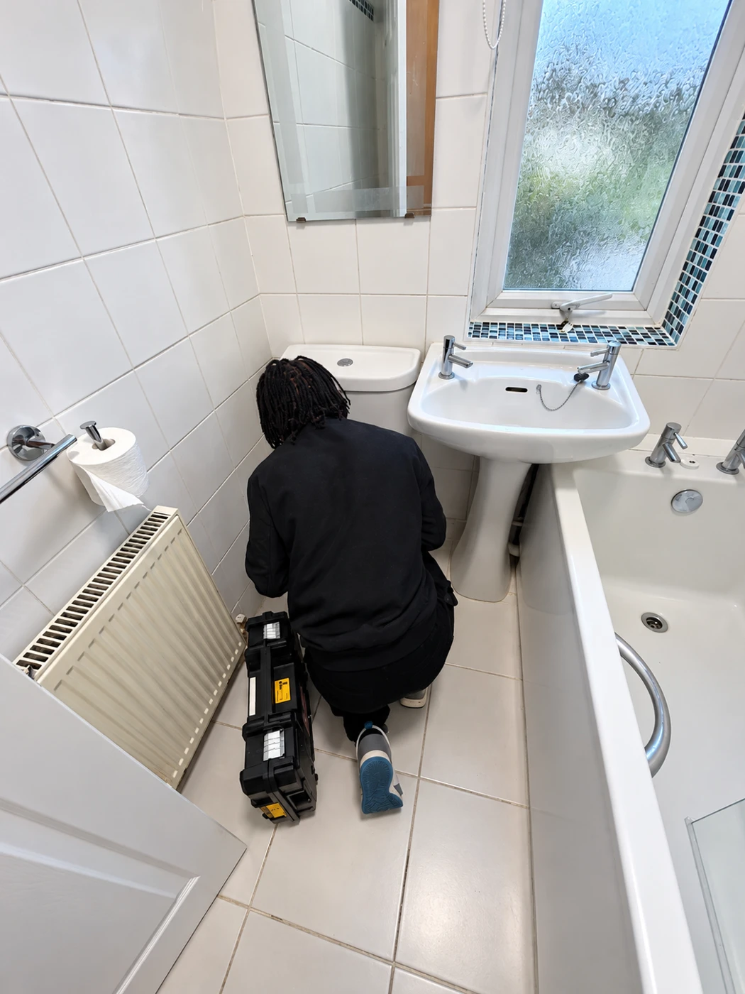 Tendy plumber carrying out bathroom maintenance